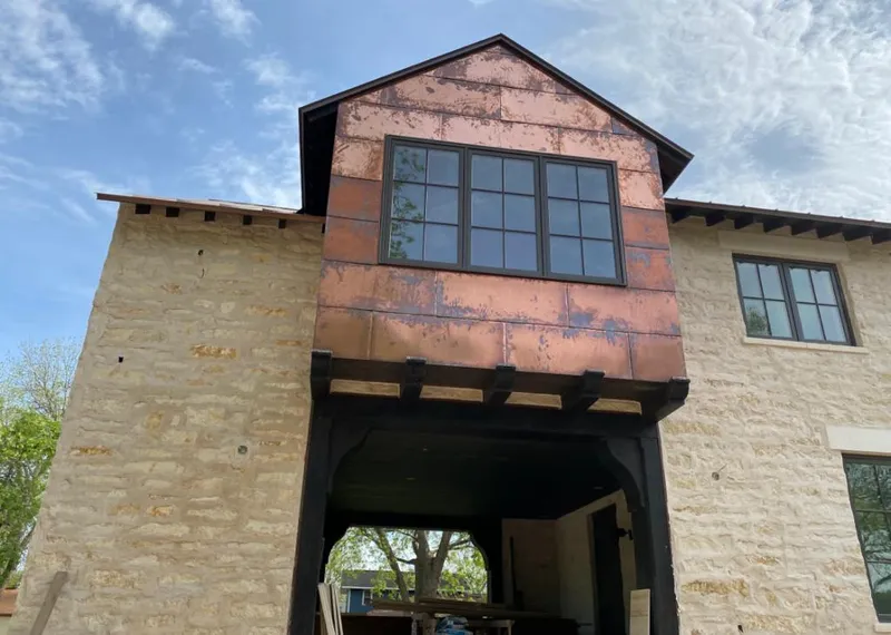 Copper metal panel facade on a stone building for Roof Repair in Yuba City